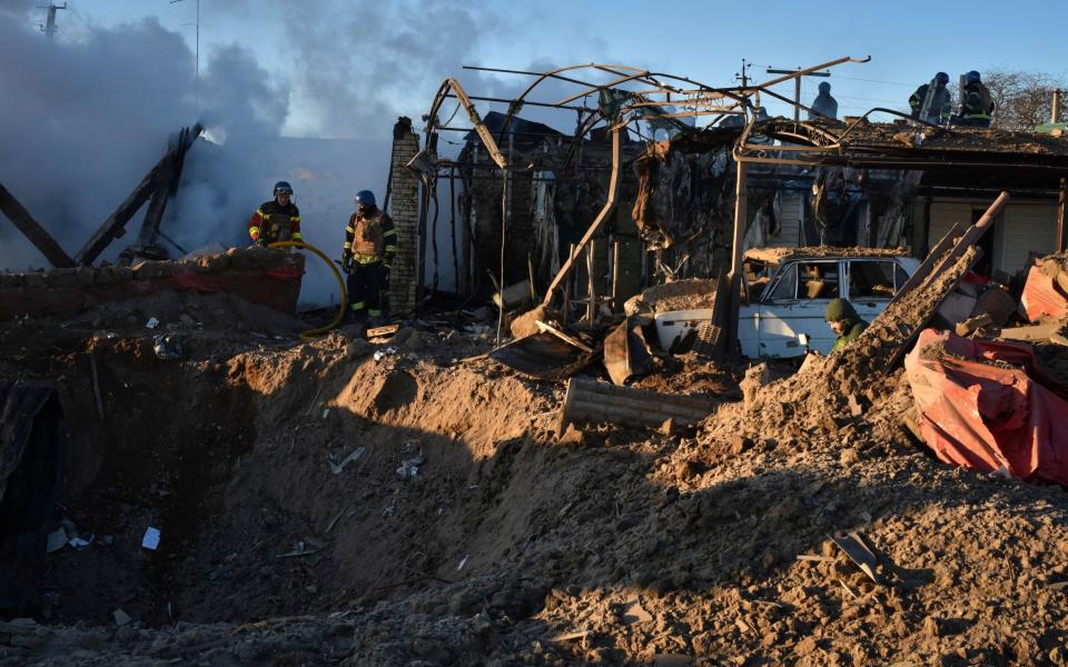 Members of the Ukrainian State Emergency Service clear the rubble at the building which was destroyed as a result of Russian strike in Zaporizhzhia - Andriy Andriyenko/AP