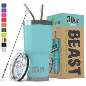 the beast coffee travel mug with steel straws and a lid next to its box in the color teal on a white background