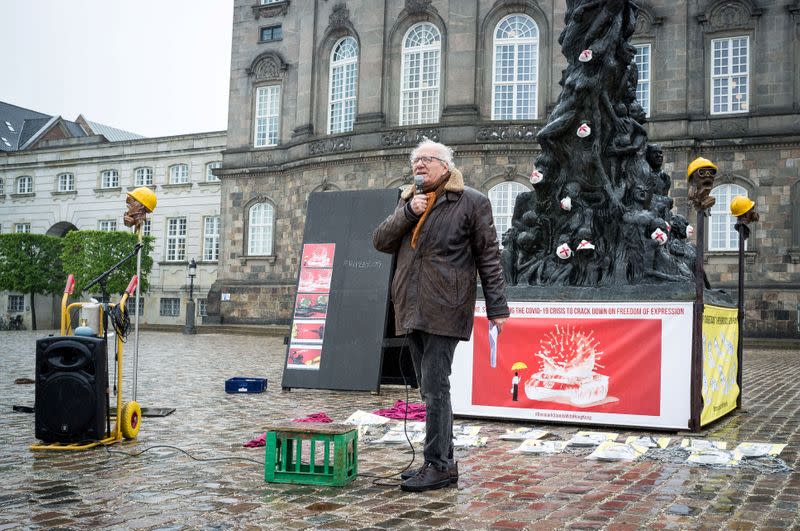 Danish sculptor Jens Galschiot is seen in front of his sculpture "The Pillar of Shame" at the Danish Parliament in Copenhagen