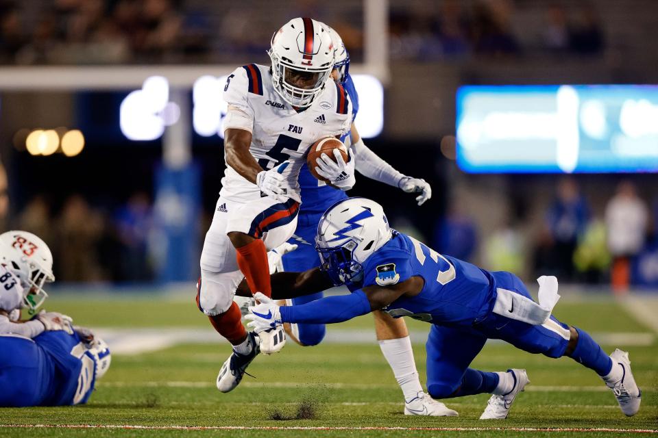 Sep 25, 2021; Colorado Springs, Colorado, USA; Florida Atlantic Owls running back Johnny Ford (5) runs through the tackle of Air Force Falcons cornerback David Eure (33) in the fourth quarter at Falcon Stadium. Mandatory Credit: Isaiah J. Downing-USA TODAY Sports