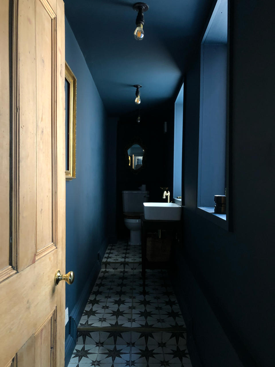 A bathroom bathed in blue paint