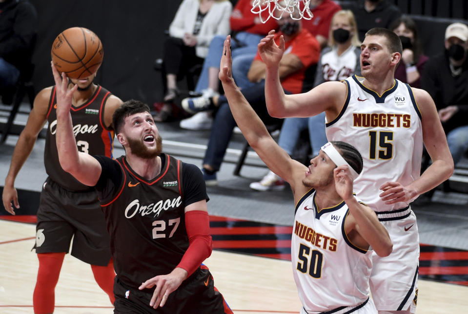 Portland Trail Blazers center Jusuf Nurkic, left, shoots the ball over Denver Nuggets forward Aaron Gordon, right, during the first half of an NBA basketball game in Portland, Ore., Sunday, May 16, 2021. (AP Photo/Steve Dykes)