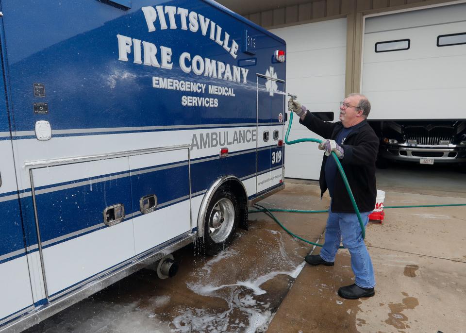 Pittsville Fire Department chief Jerry Minor washes an ambulance at the firehouse in Pittsville. Minor's department is one of many across Wisconsin facing a shortage of first responders.