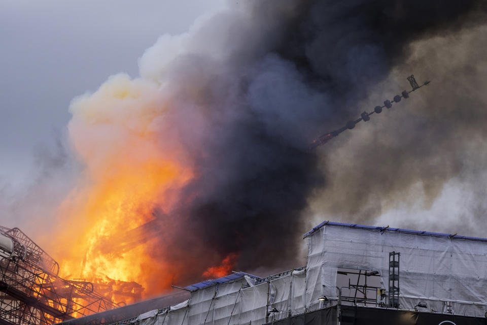 The spire collapses as fire and smoke rise out of the Old Stock Exchange, Boersen, in Copenhagen, Denmark, Tuesday, April 16, 2024. One of Copenhagen’s oldest buildings is on fire and its iconic spire has collapsed. The building, which is situated next to the Christiansborg Palace where the parliament sits, is a popular tourist attraction. Its distinctive spire, in the shape of the tails of four dragons twined together, reached a height of 56 meters (184 feet). (Ida Marie Odgaard/Ritzau Scanpix via AP)