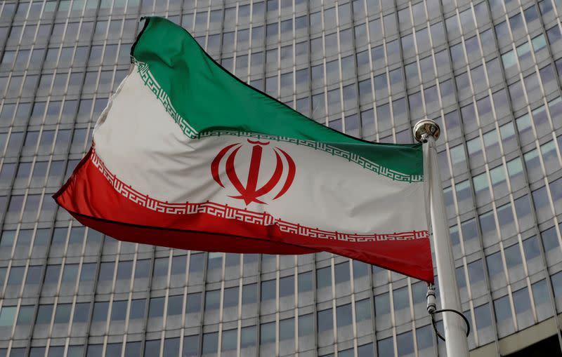 An Iranian flag flutters in front of the IAEA headquarters in Vienna