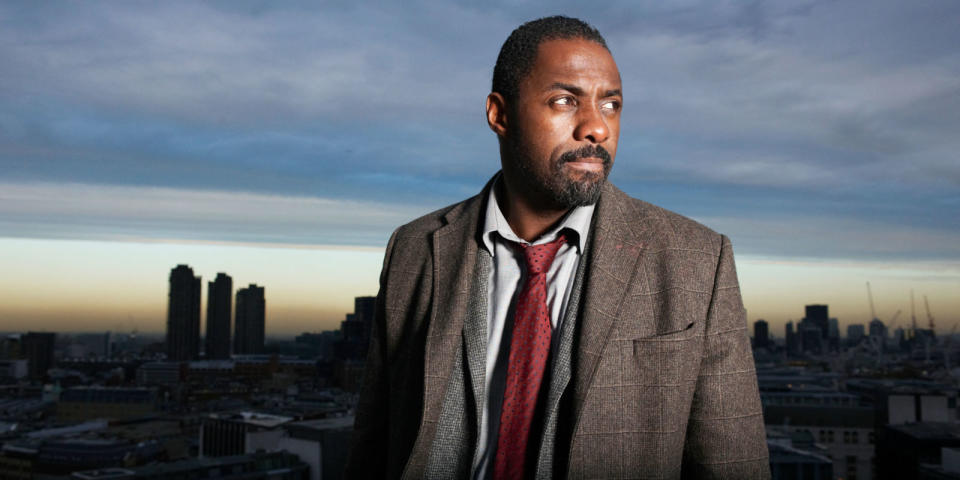 A still from Luther shows Idris Elba as the titular corrupt cop standing in front of the London Skyline