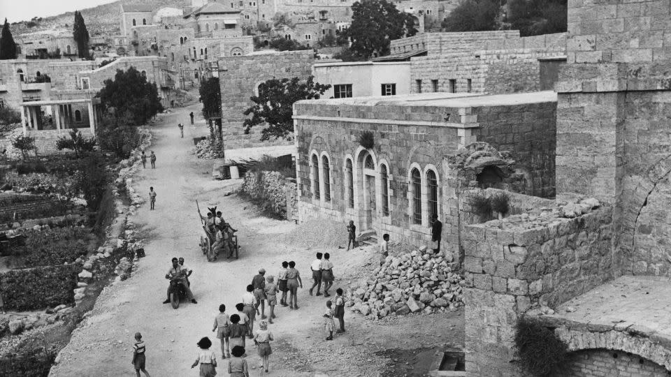 Israeli students on their way to school in Ein Karem circa 1955. The buildings on the right show damage dating from the 1948 Arab-Israeli War. - George Pickow/Three Lions/Hulton Archive/Getty Images