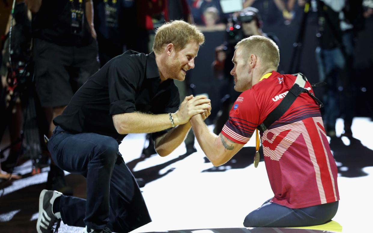 The Duke of Sussex greets Mark Ormrod at the indoor rowing at the Invictus Games in Toronto in 2017