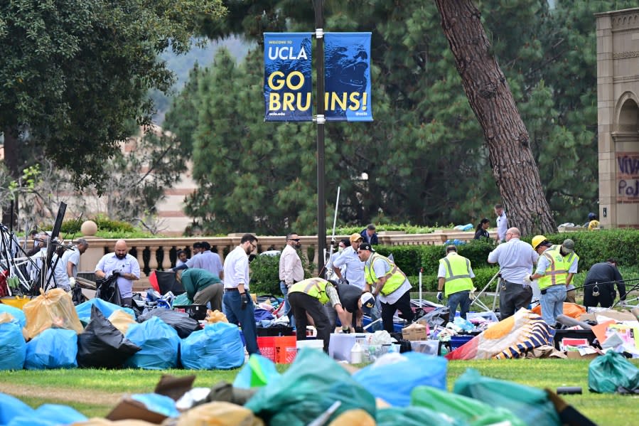 Workers clean up the University of California, Los Angeles (UCLA) campus after police evicted pro-Palestinian students, in Los Angeles, California, early on May 2, 2024. Hundreds of police tore down protest barricades and began arresting students early Thursday at the University of California, Los Angeles – the latest flashpoint in an eruption of protest on US campuses over Israel’s war against Hamas in Gaza. (Photo by Frederic J. Brown / AFP) (Photo by FREDERIC J. BROWN/AFP via Getty Images)