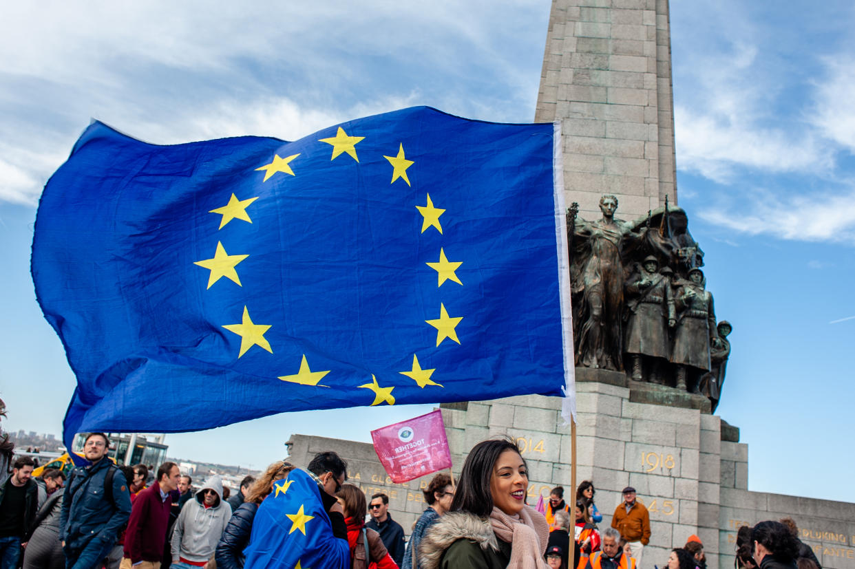  A woman is seen holding a flag of the EU in front of the monument at the Poulaert square during the protest. A day before the anniversary of the founding Treaty of the European Union, citizens and civil society organizations took the streets of Brussels to make a stand, two months before the European elections. The march was organized by together platform, an initiative launched by an alliance of progressive political groups from across Europe. They stand for solidarity, democracy, and peace against the real threat to their core European values. (Photo by Ana Fernandez / SOPA Images/Sipa USA) 