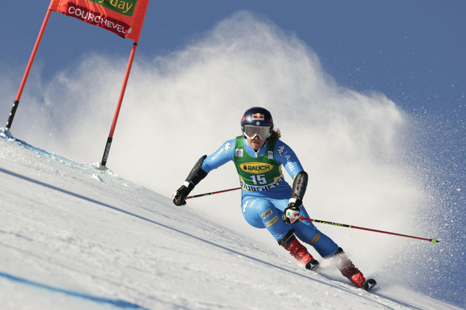 FILE - Italy's Sofia Goggia speeds down the slope during the first run of an alpine ski, women's World Cup giant slalom, in Courchevel, France, Tuesday, Dec. 21, 2021. Mikaela Shiffrin is hoping to enter all five individual Alpine skiing races at the Beijing Olympics and add to her career total of three Winter Games medals. The 26-year-old American could be the star of the show but she will be challenged by Slovakia's Petra Vlhova and Italy's Goggia. (AP Photo/Giovanni Maria Pizzato, File)