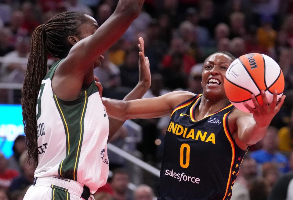 Seattle Storm center Ezi Magbegor (13) guards Indiana Fever guard Kelsey Mitchell (0) as she shoots the ball during the second half of a game Sunday, Aug. 18, 2024, at Gainbridge Fieldhouse in Indianapolis. The Fever defeated the Storm 92-75.