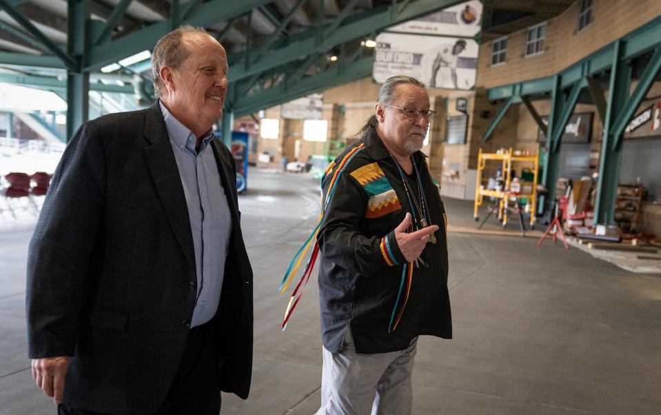 Bruce Schumacher, Indianapolis Indians chairman and CEO, and Chief Brian Buchanan of the Miami Nation of Indians of Indiana walk the concourse at Victory Field on Wednesday.