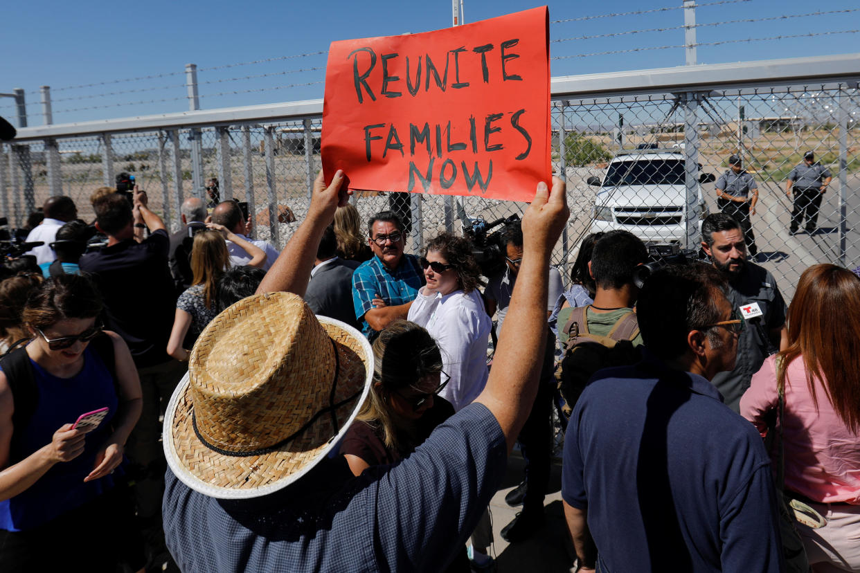 A protester holds up a sign as mayors from U.S. cities are stopped from entering the children's tent encampment in Tornillo, Texas, on June 21. (Photo: Mike Blake / Reuters)