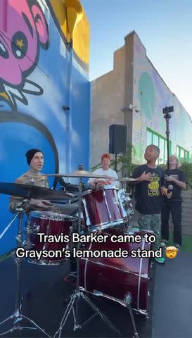 <p>Charlie Rocket Aka BIG DREAM Instagram</p> Travis Barker jams with 9-year-old Grayson Roberts during surprise visit to his lemonade stand