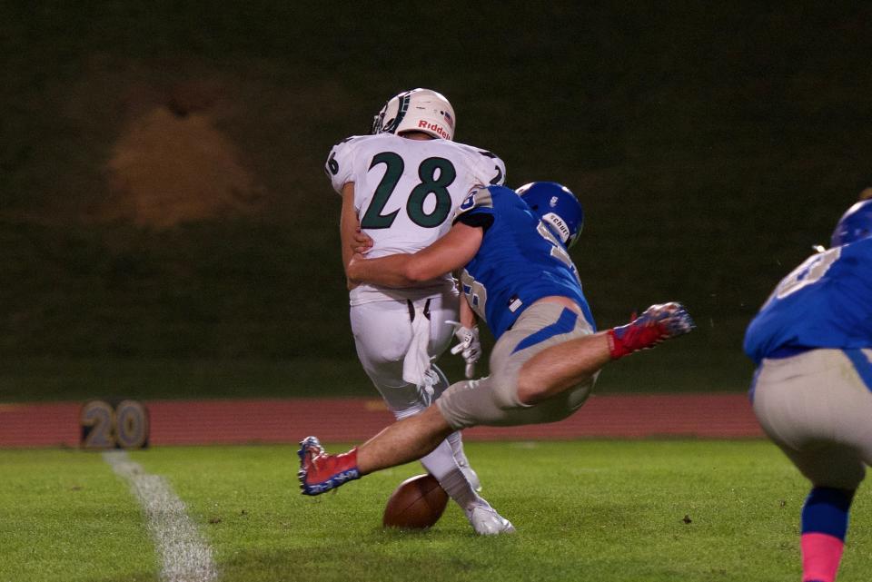 Pennridge running back Nate Mossbrook fumbles the ball after a hit from Bensalem's Jose Garcia on Friday, Oct 8, 2021. Pennridge defeated Bensalem 45-0.