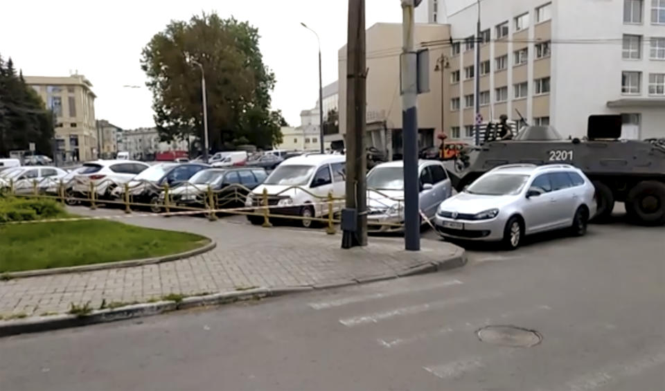 In this image take from video, the scene as streets are closed off, with an armoured security vehicle, right, after an armed man seized a bus and took some 20 people hostage in the city centre of Lutsk, some 400 kilometers (250 miles) west of Kyiv, Ukraine on Tuesday July 21, 2020. The assailant is armed and carrying explosives, according to a Facebook statement by Ukrainian police. Police officers are trying to get in touch with the man and they have sealed off the area. (AP Photo)