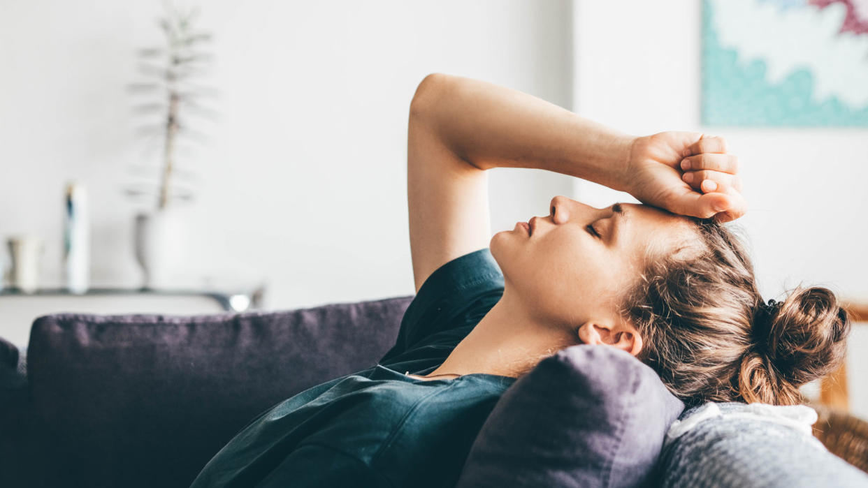  anxious young woman sat on her sofa 