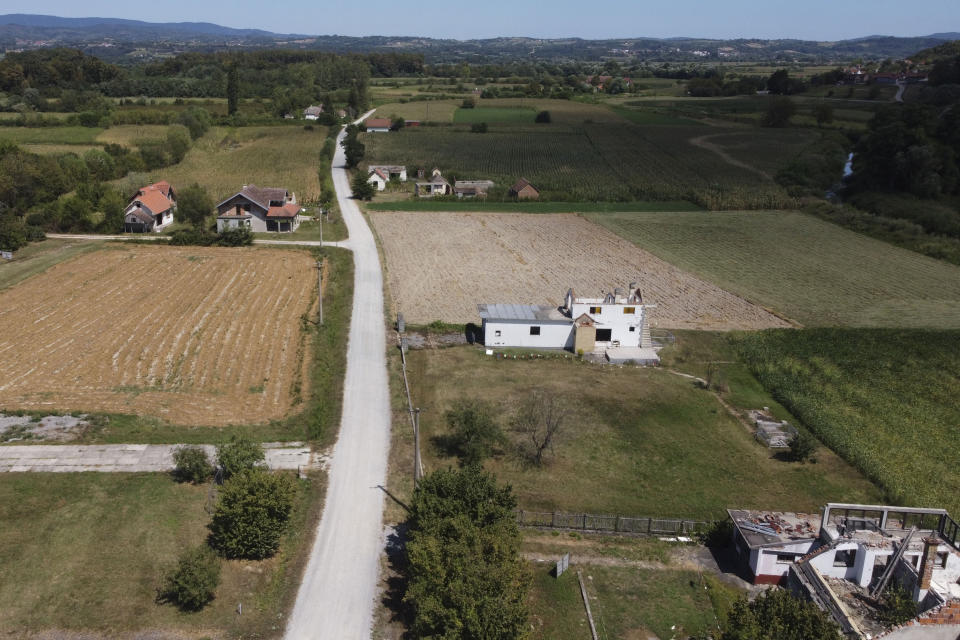 Abandoned and roofless houses bought by Rio Tinto company in the village of Gornje Nedeljice, in the fertile Jadar Valley in western Serbia, Tuesday, Aug. 6, 2024. (AP Photo/Darko Vojinovic)