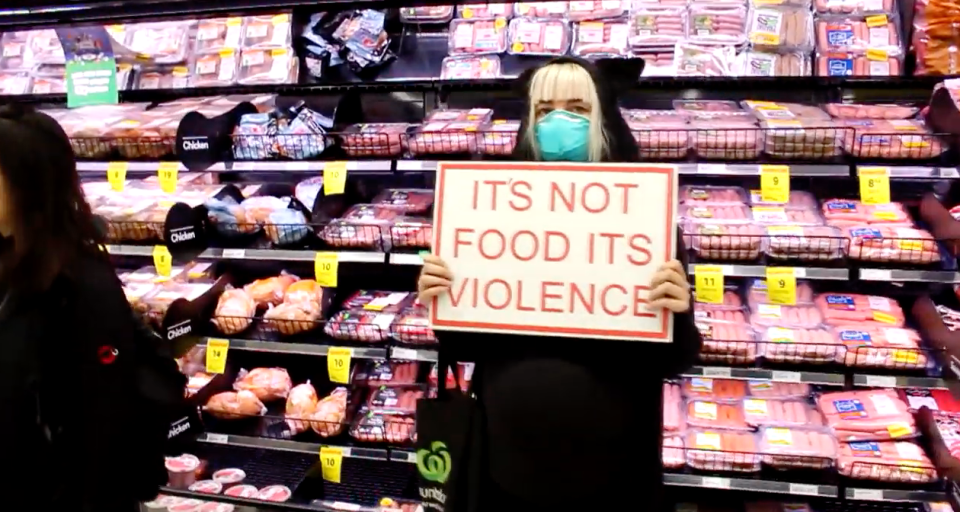 A Direct Action Everywhere protester stands in front of the meat aisle in a Countdown in Auckland's St Lukes on Sunday. 