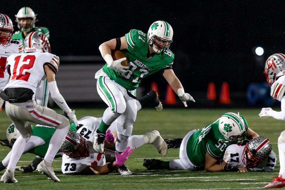 Mogadore senior Mason Williams runs through a line of defenders during a regional semifinal football game against the Cuyahoga Heights Red Wolves on Saturday, November 12 in Twinsburg.