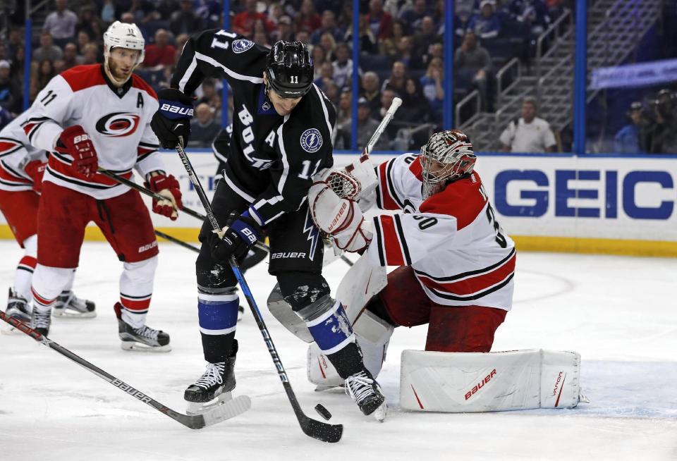 Carolina Hurricanes goalie Cam Ward makes a save against Tampa Bay Lightning's Brian Boyle during the second period of an NHL hockey game Saturday, Dec. 31, 2016, in Tampa, Fla. (AP Photo/Mike Carlson)