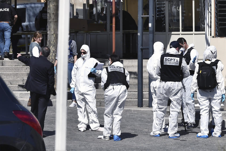 Police officers investigate after a man wielding a knife attacked residents venturing out to shop in the town under lockdown, Saturday April 4, 2020 in Romans-sur-Isere, southern France. The alleged attacker was arrested by police nearby, shortly after the attack. Prosecutors did not identify him. They said he had no documents but claimed to be Sudanese and to have been born in 1987. (AP Photo)