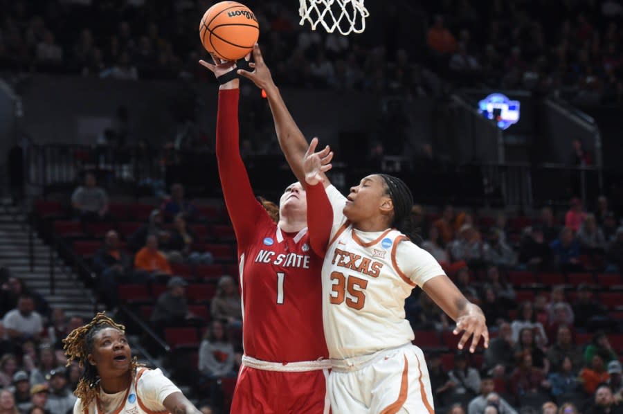 Texas forward Madison Booker, right, and forward DeYona Gaston, left, guard North Carolina State center River Baldwin (1) during the first half of an Elite Eight college basketball game in the women’s NCAA Tournament, Sunday, March 31, 2024, in Portland, Ore. (AP Photo/Steve Dykes)