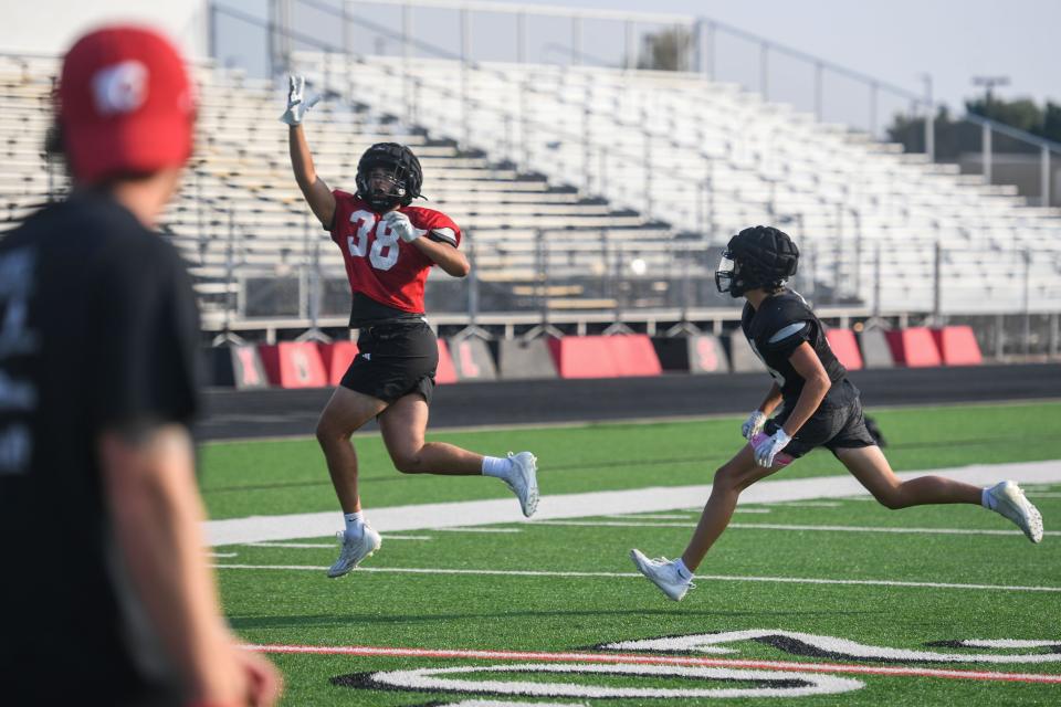 Noah Bailous (38) reaches for the football at Brandon Valley High School in Brandon, South Dakota on Friday, Aug. 18, 2023.