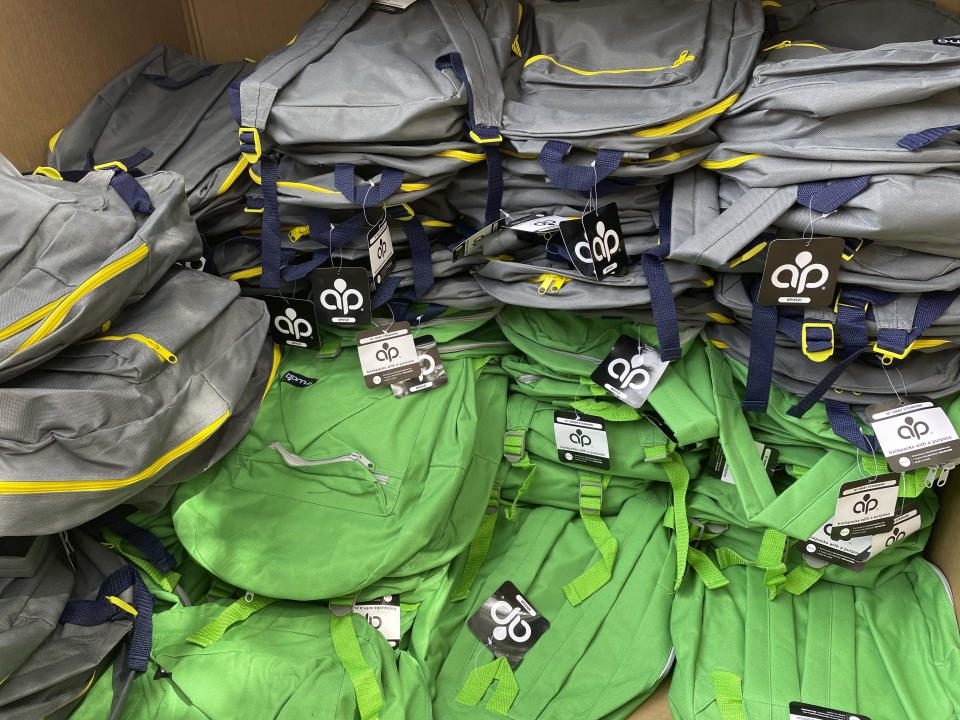 Backpacks and school supplies are unpacked at a Chicago Public Schools back-to-school supply giveaway at Theodore Roosevelt High School in Chicago, on July 22, 2022. This back-to-school shopping season, parents, particularly in the low-to-middle income bracket, are focusing on the basics like no frills rain boots, while also trading down to cheaper stores, including second-hand clothing, as surging inflation takes a toll on their household budgets. (AP Photo/Claire Savage)