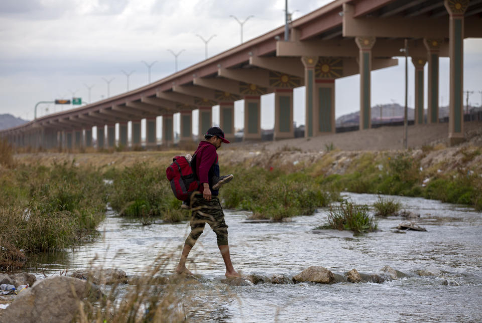 A migrant from Ecuador crosses the Rio Grande toward El Paso, Texas, from Ciudad Juarez, Mexico, Sunday, Dec. 18, 2022. Texas border cities were preparing Sunday for a surge of as many as 5,000 new migrants a day across the U.S.-Mexico border as pandemic-era immigration restrictions expire this week, setting in motion plans for providing emergency housing, food and other essentials. (AP Photo/Andres Leighton)