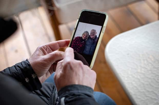 McVinnie shares a photo of herself and her husband, who is recovering in hospital from a massive stroke. He's now in a hospital in Orillia, Ont., an hour's drive from the couple's home. (Evan Mitsui/CBC - image credit)