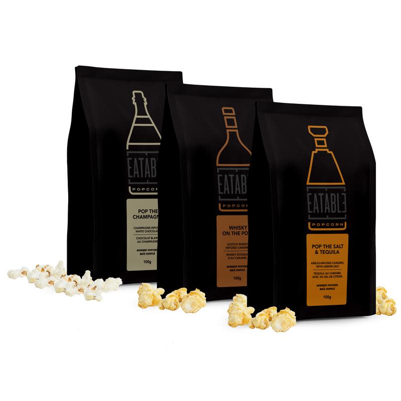 Three bags of Top Shelf Trio Gourmet Popcorn in black bags