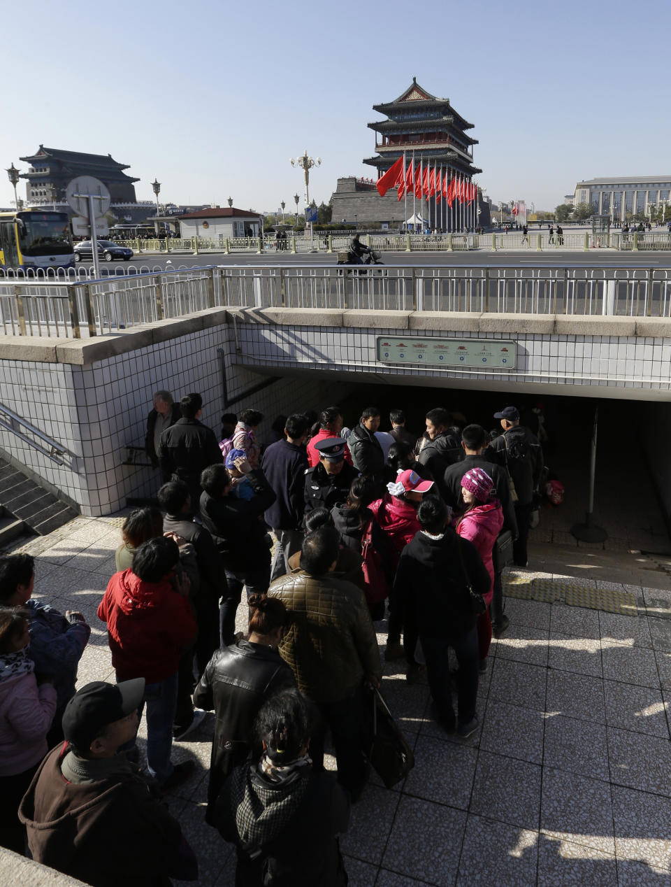 Visitors wait in queue to get their security check near Tiananmen Square during the 18th Communist Party Congress in Beijing Monday, Nov. 12, 2012. (AP Photo/Lee Jin-man)