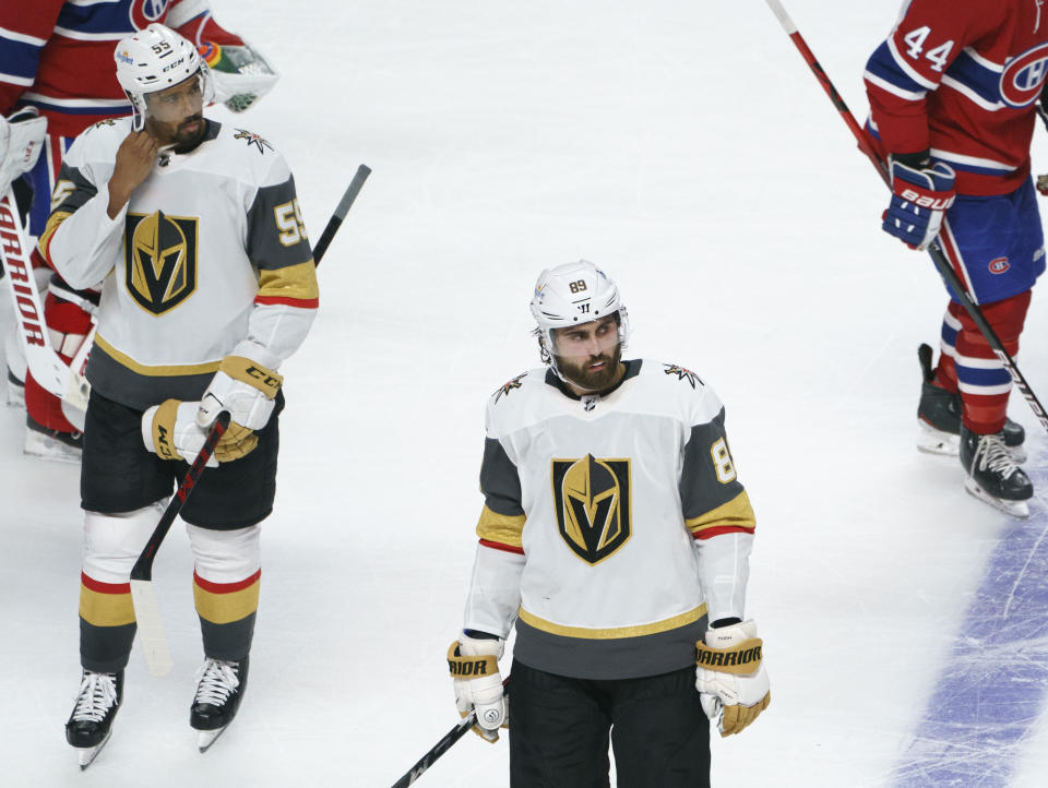 Vegas Golden Knights' Keegan Kolesar, left, and Alex Tuch skate off the ice after the team's loss to the Montreal Canadiens in overtime in Game 3 of an NHL hockey semifinal series, Friday, June 18, 2021, in Montreal. (Paul Chiasson/The Canadian Press via AP)