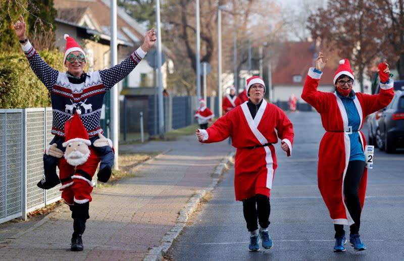 People dressed as Santa Claus race through the streets of Michendorf