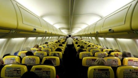 FILE PHOTO: A cabin crew member serves passengers onboard a Ryanair passenger aircraft travelling from Madrid International Airport to Bergamo Airport, Italy, January 13, 2018. Picture taken January 13, 2018. REUTERS/Stefano Rellandini/File Photo