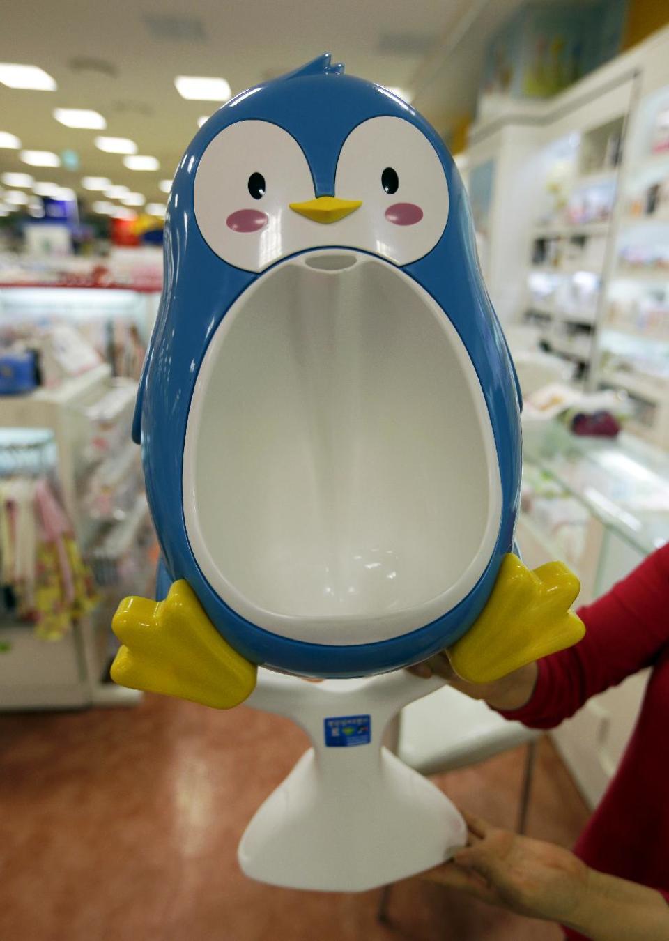 This May 10, 2013 photo shows a penguin shaped urinal for boy's training is shown at a shop in Seoul, South Korea. For some parents, summertime is potty training time. And like so many aspects of life with kids, potty training means gear, lots of gear. The choices in potty seats and chairs proliferated and sprouted all manner of bells and whistles. (AP Photo/Lee Jin-man, file)