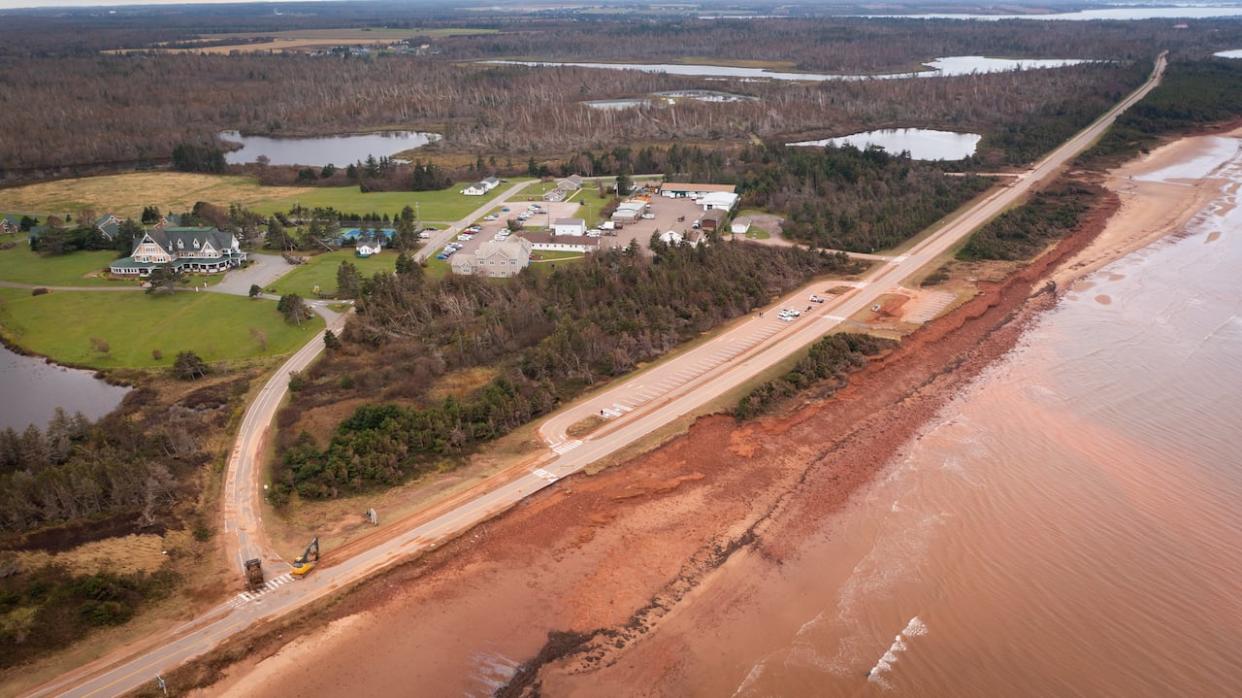 The road by the famous hotel at Dalvay, P.E.I., was undermined by coastal flooding during post-tropical storm Fiona in 2022.  (Shane Hennessey/CBC - image credit)