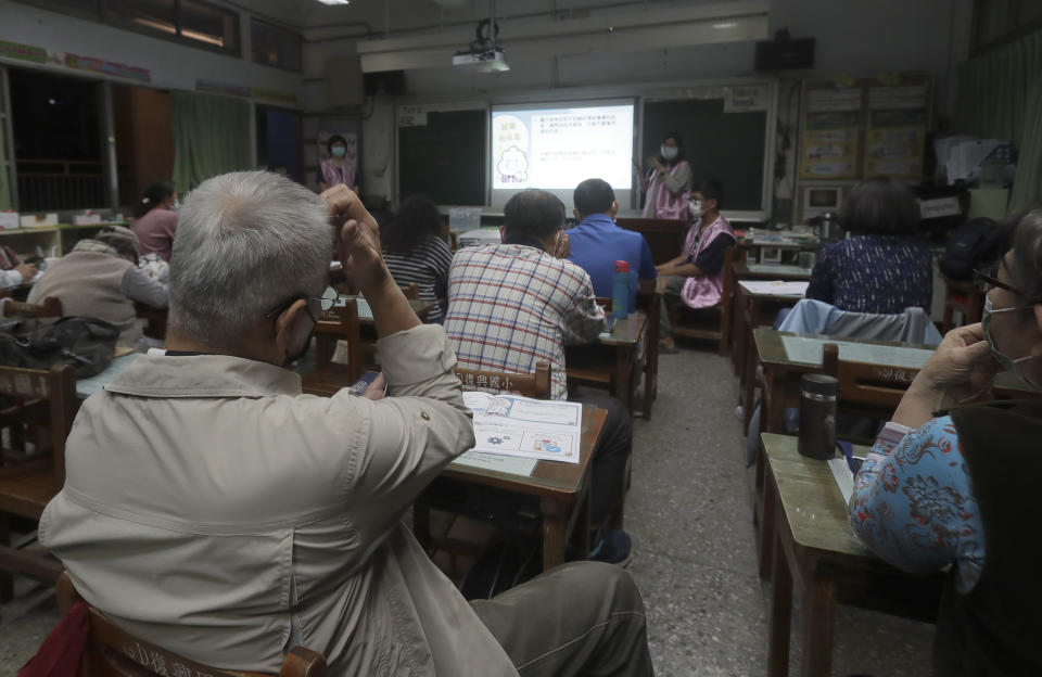 Students of Fake News Cleaner listen to volunteers as they learn how to use the LINE app to identify fake news during a class in Kaohsiung City, southern Taiwan, Thursday, March 16, 2023. An anti-misinformation group in Taiwan called Fake News Cleaner has hosted more than 500 events, connecting with college students, elementary-school children — and the seniors that, some say, are the most vulnerable to such efforts. (AP Photo/Chiang Ying-ying)