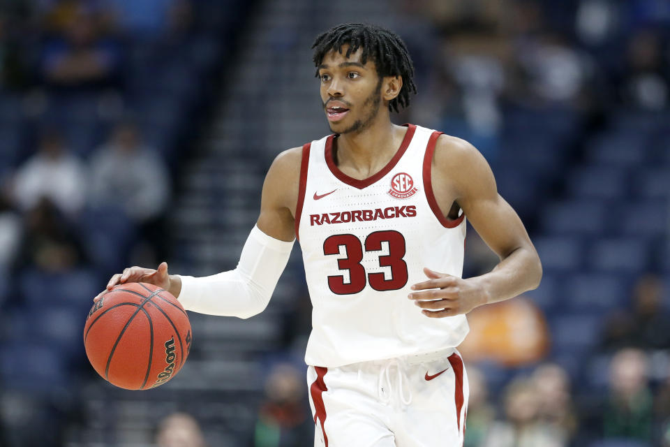 FILE - In this March 11, 2020, file photo, Arkansas guard Jimmy Whitt Jr. plays against Vanderbilt in the second half of an NCAA college basketball game in the Southeastern Conference Tournament in Nashville, Tenn. As thousands of college athletes and coaches across the country try to adjust after the sudden suspensions of entire seasons of competition and perhaps more so the camaraderie of daily practices, training sessions and team meals, communication specialists and mental health professionals are encouraging those involved to allow these young men and women to go through the stages of grieving as needed. At Arkansas, the athletic department is keeping tabs on every student-athlete at all times through a detailed spreadsheet, when someone is on the move, they all know. So, when men's basketball player Jimmy Whitt returns home to Columbia, Missouri, in the coming days, his coaches will monitor his movements by checking in until he reports he has safely made it. (AP Photo/Mark Humphrey, File)