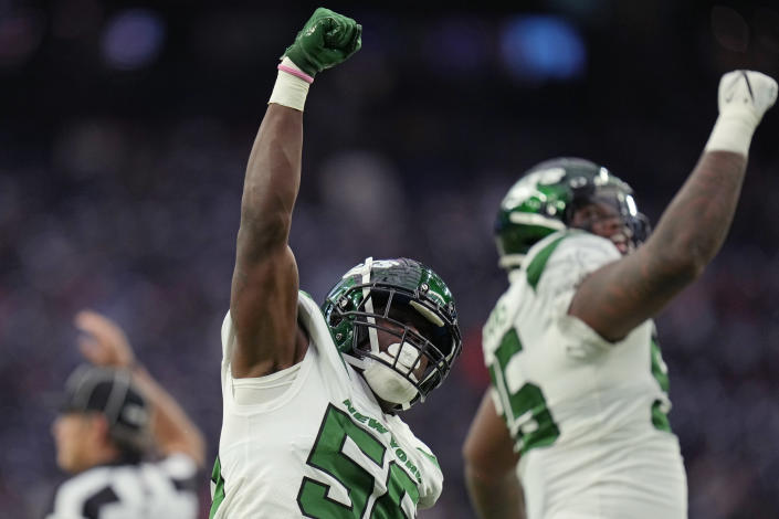 New York Jets outside linebacker Quincy Williams (56) celebrates a stop with defensive tackle Quinnen Williams (95) in the first half of an NFL football game against the Houston Texans in Houston, Sunday, Nov. 28, 2021. (AP Photo/Eric Smith)