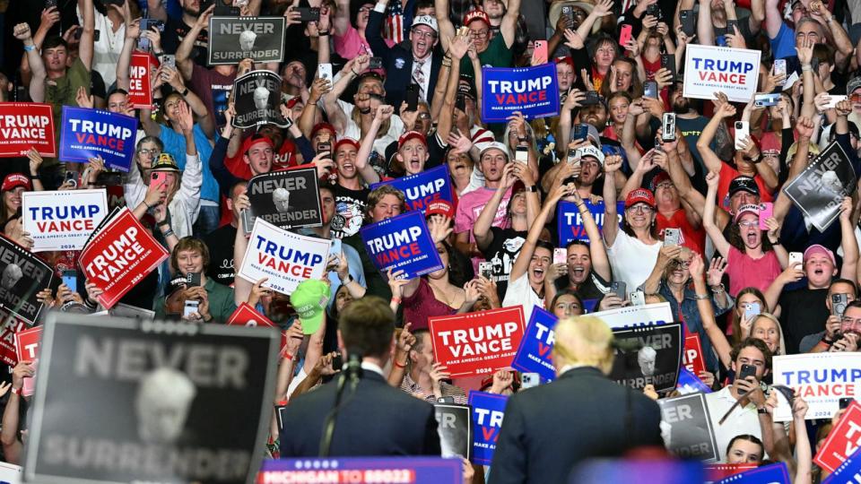 PHOTO: The crowd cheers as former President Donald Trump with vice presidential nominee J.D. Vance attend their first campaign rally together at Van Andel Arena in Grand Rapids, Mich., July 20, 2024. (Jim Watson/AFP via Getty Images)