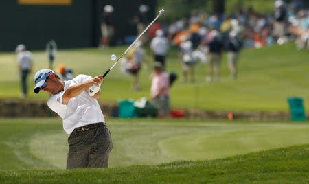 FILE PHOTO: Scott McCarron of the U.S. hits from the fairway bunker on the 18th hole during the third round of the Quail Hollow Championship in Charlotte, North Carolina May 1, 2010. REUTERS/Jason Miczek/File Photo