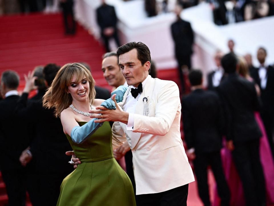 Maya Hawke and Rupert Friend dance together at the 2023 Cannes Film Festival.