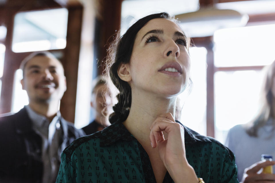 a man standing behind a woman