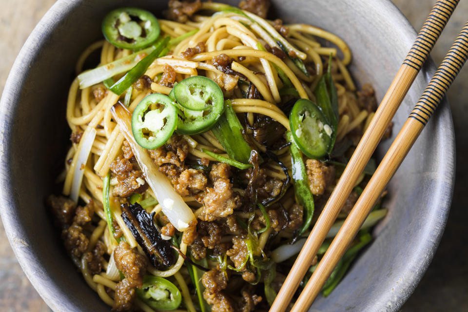 This image released by Milk Street shows a recipe for scallion noodles with pork. (Milk Street via AP)