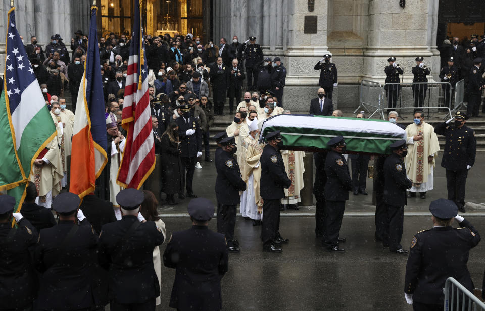 The casket of NYPD Officer Jason Rivera is carried to a hearse outside St. Patrick's Cathedral after his funeral service, Friday, Jan. 28, 2022, in New York. Rivera and his partner, Officer Wilbert Mora, were fatally wounded when a gunman ambushed them in an apartment as they responded to a family dispute last week. (AP Photo/Yuki Iwamura)