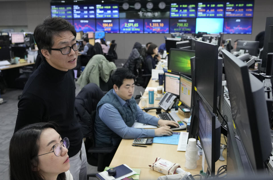 Currency traders watch monitors at the foreign exchange dealing room of the KEB Hana Bank headquarters in Seoul, South Korea, Tuesday, Feb. 6, 2024. Shares are mixed in Asia, where Chinese markets advanced after a government investment fund said it would step up stock purchases. (AP Photo/Ahn Young-joon)