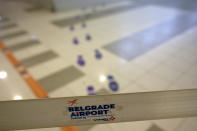 A corridor with footprint stickers is pictured at the airport in Belgrade, Serbia, Wednesday, Sept. 21, 2022. Large numbers of Russians rushed to book one-way tickets out of the country while they still could after Russian President Vladimir Putin announced a partial mobilization of military reservists for the war in Ukraine. (AP Photo/Darko Vojinovic)